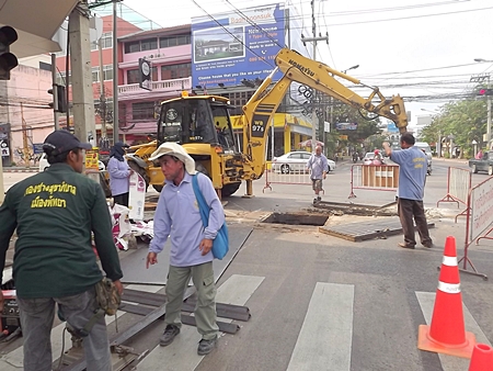 City workers repair damaged drainage pipes and grates at the intersection of Central Road with 3rd Road.